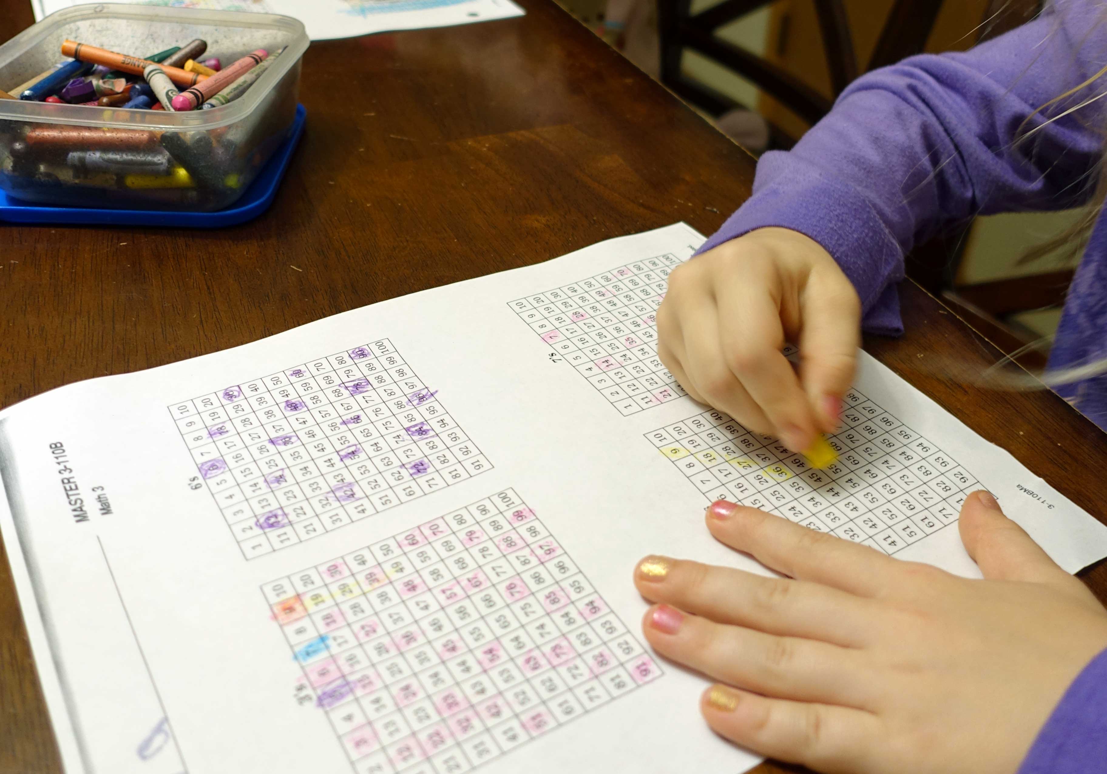 Child completing math worksheet